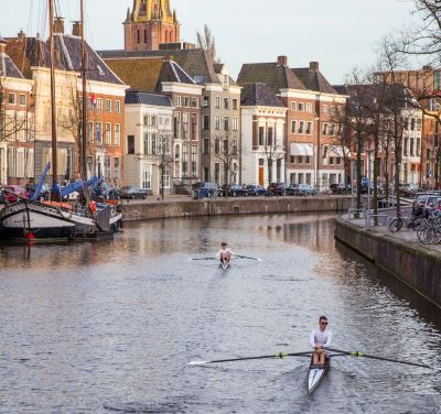 Groningen - a man rowing a boat on a river