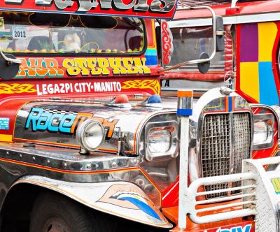 a colorful bus parked in front of a building