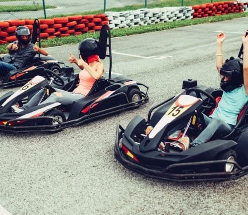 a group of people riding go karts in a race
