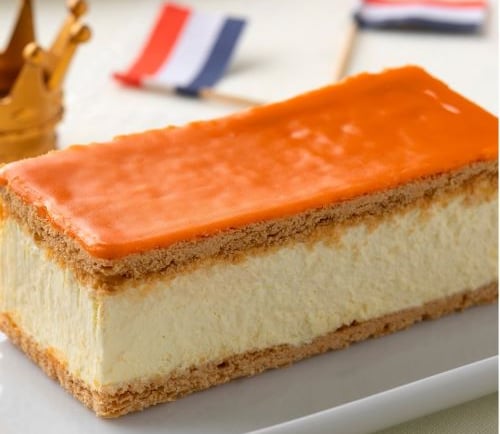 a piece of cake with orange and white icing