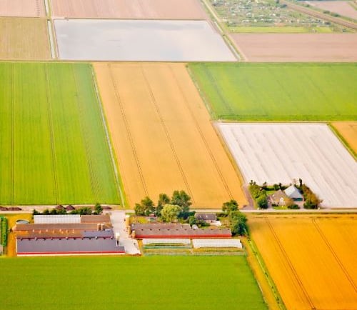 a farm with a barn and a barn in the background