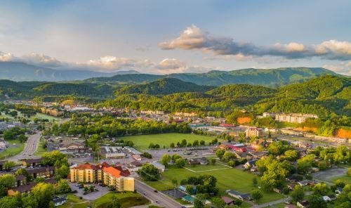 a cityscape of pigeon forge with mountains in the background