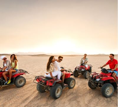 a group of people riding on four wheelers