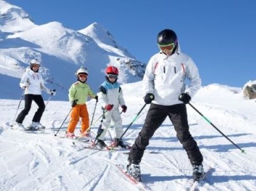 a group of people skiing down a mountain