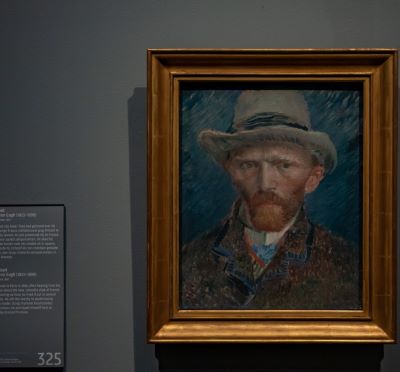van gogh - a painting of a man with a hat on a wall