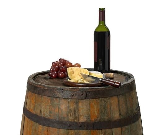 a wine barrel with cheese and wine