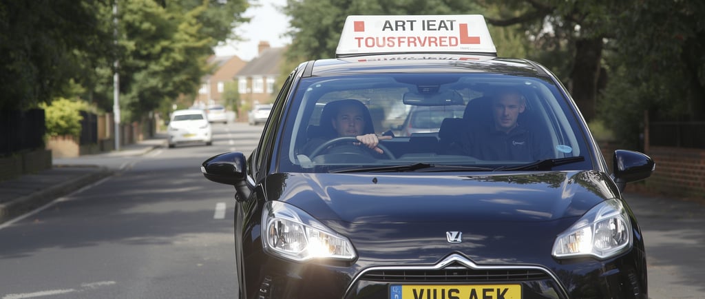Learner driver in Woodford taking a lesson with a patient driving instructor.