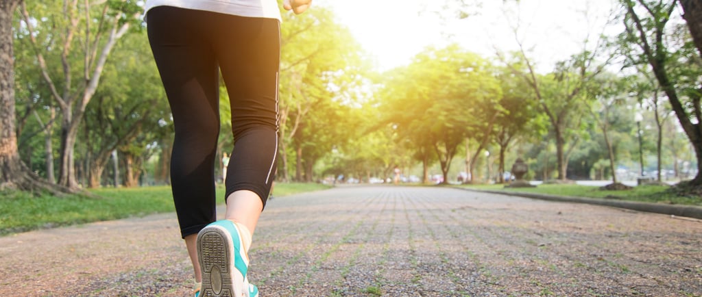 a woman running on a path in the park