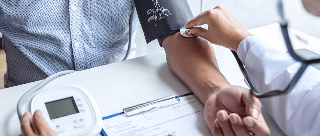 a doctor checking a patient's blood pressure