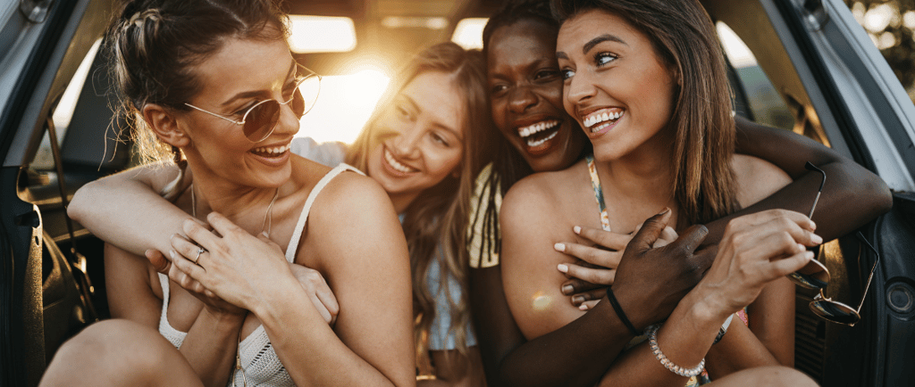 a group of friends hanging out in the back of a car
