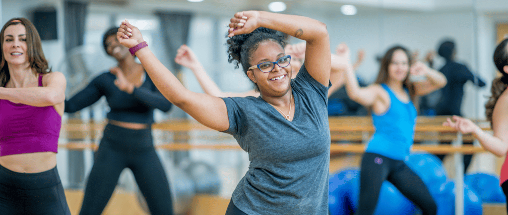 a woman in a gray shirt and black pants