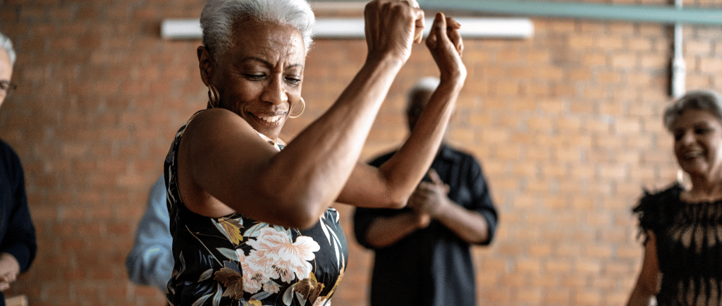 a woman in a floral dress dancing with a man in a suit