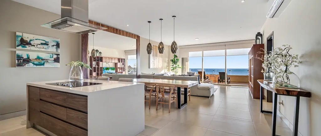 Modern luxury penthouse kitchen and open-concept living area with ocean views in Los Cabos