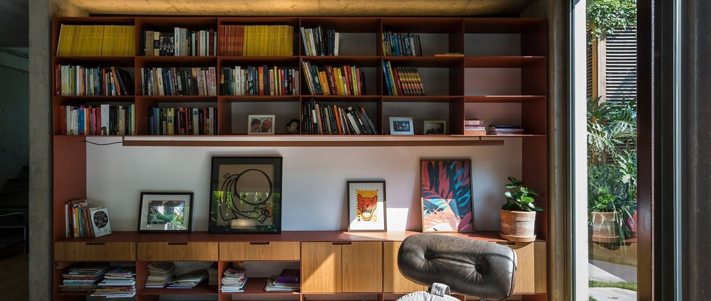 A well-organized bookshelf with ornament frames