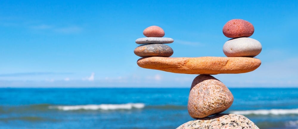a stack of rocks balancing on a beach
