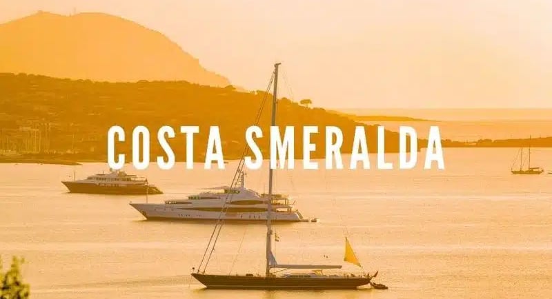 Luxury yacht illuminated by the golden light of sunset on the emerald sea of Sardinia’s northeastern