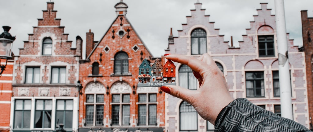 a person holding a miniature model of a miniature fire hydrant