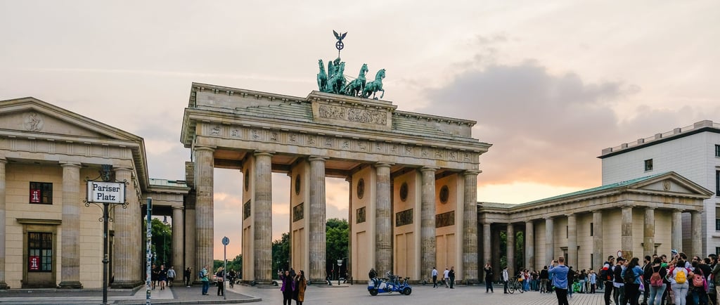 a group of people standing around a large building