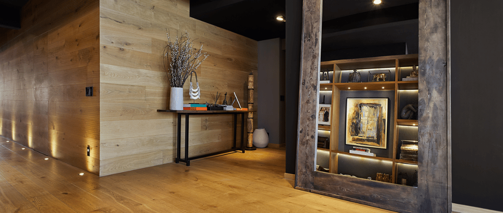 a hallway with a wooden floor and a mirror