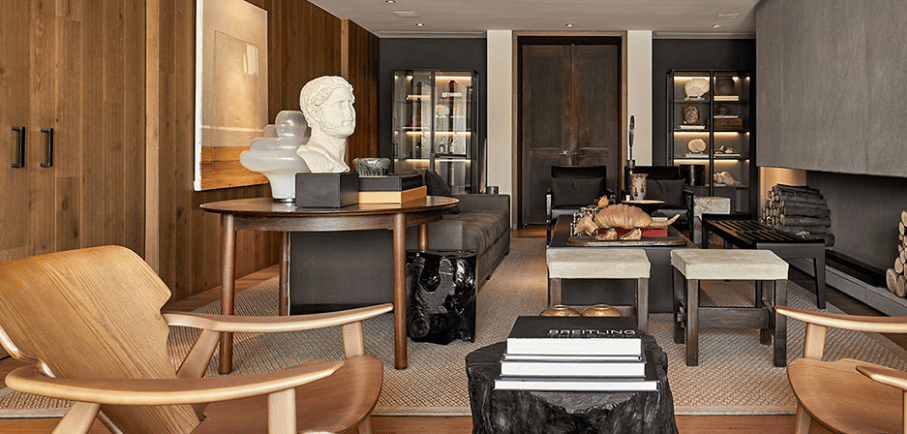 a living room with a large stone fireplace and a large stone fireplace