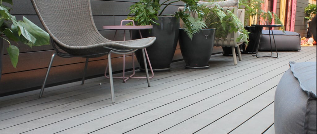 a patio with a chair and a table