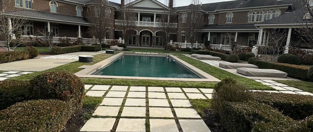 a large pool with a pool and a house in the background