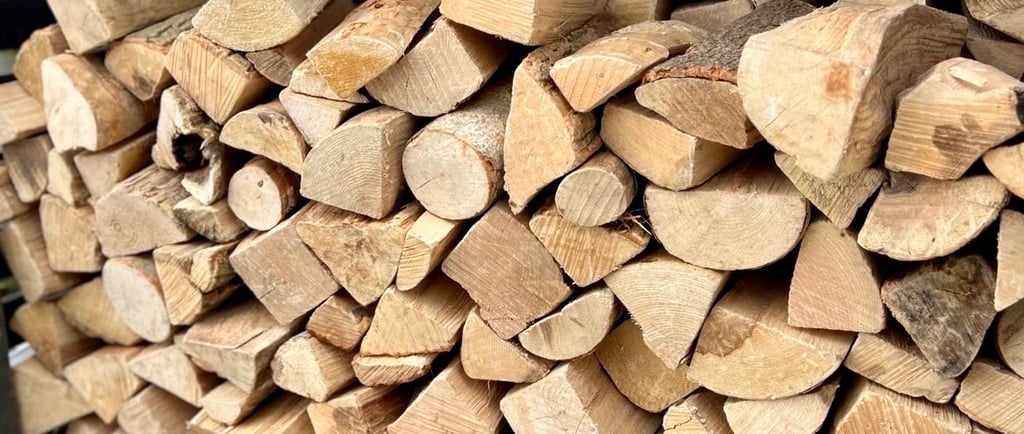 Stacked kiln dried firewood logs in a log store in Cambridgeshire
