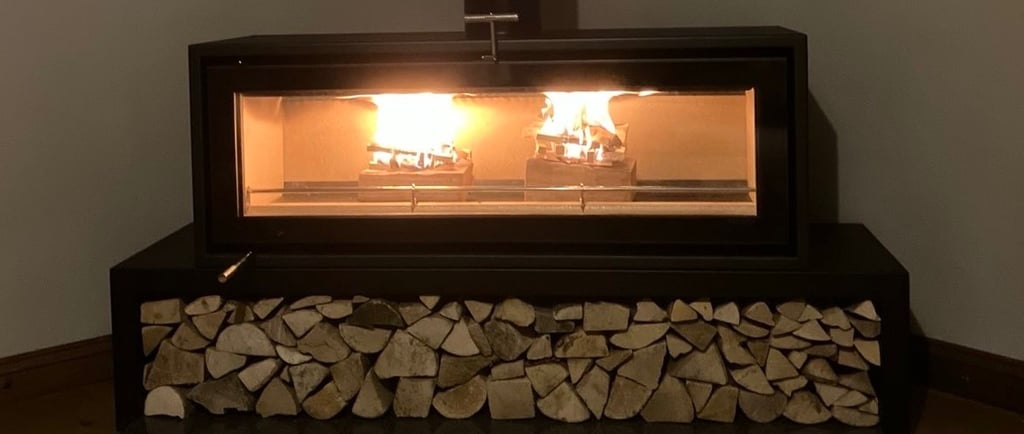 A log burning stove with stacked Ready To Burn kiln dried hardwood logs