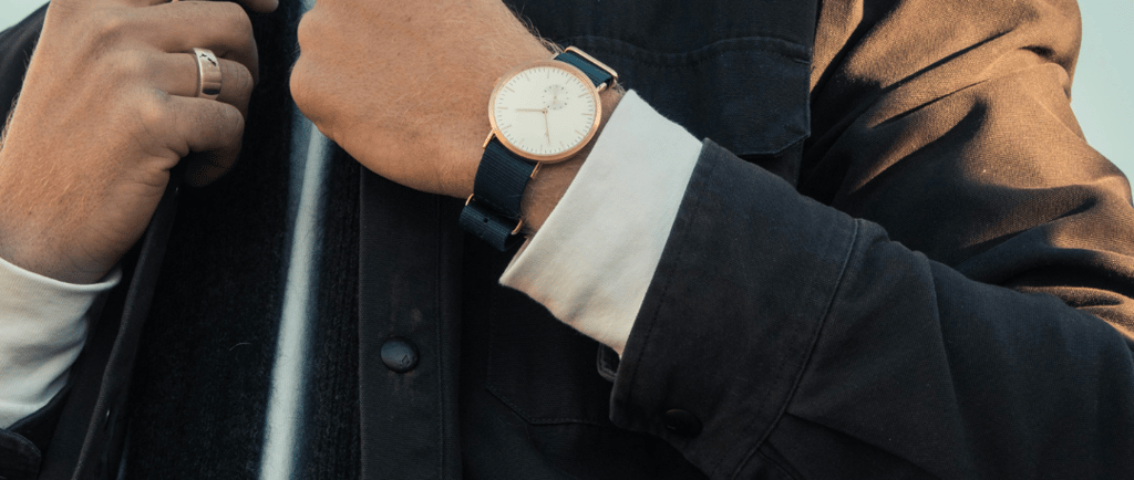 a man in a black jacket and a watch