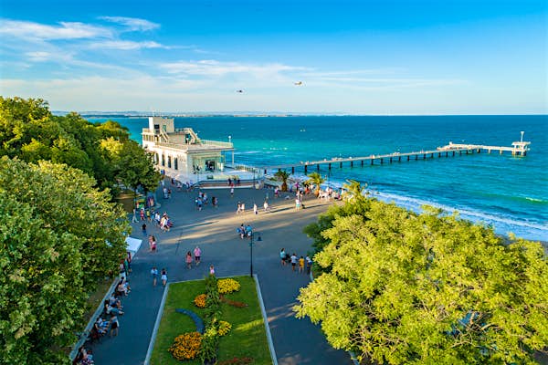 a view of a beach with people walking around