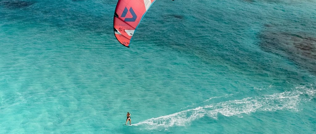 Kitesurfer on the ocean, symbolizing presence, patience, and flow in mindful practice.