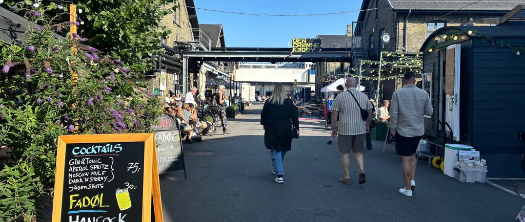 three people walking mindfully under a sign in a Copenhagen