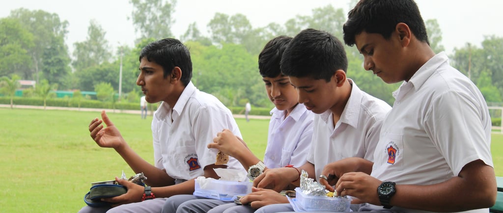 school students having lunch together