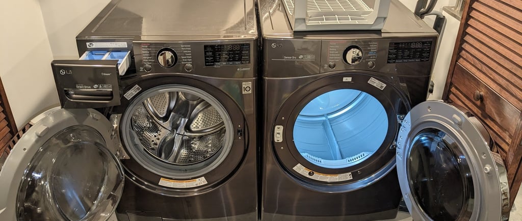 LG washer on the left while LG dryer on the right both doors are open