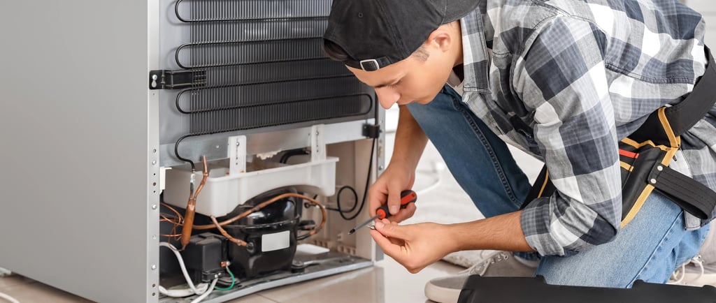a person repairing a fridge
