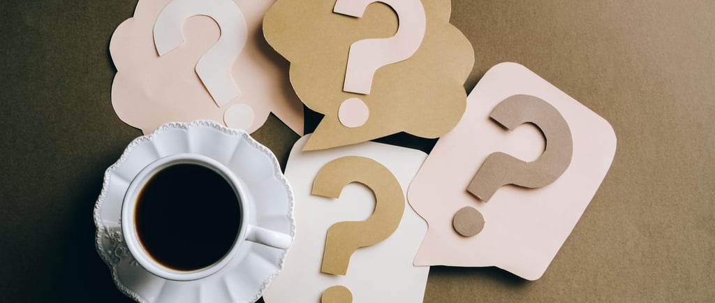 a cup of coffee with question mark on it