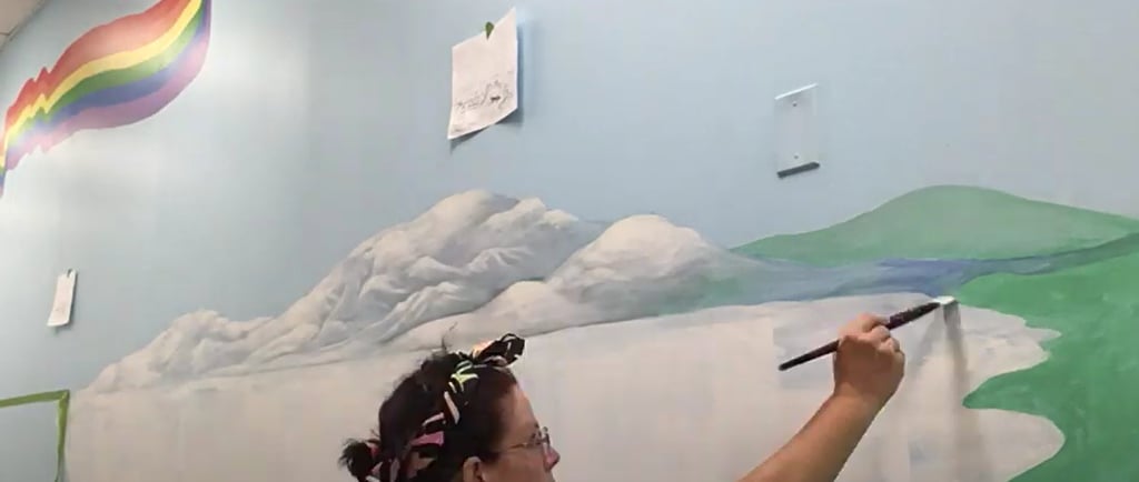 Marcine painting a bespoke mural at a Union County, NJ preschool