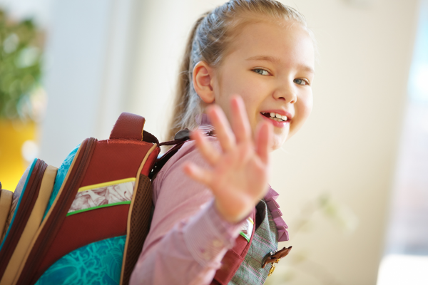 Niña diciendo adios con la mano