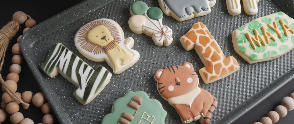 a tray of cookies with a variety of zoo animals
