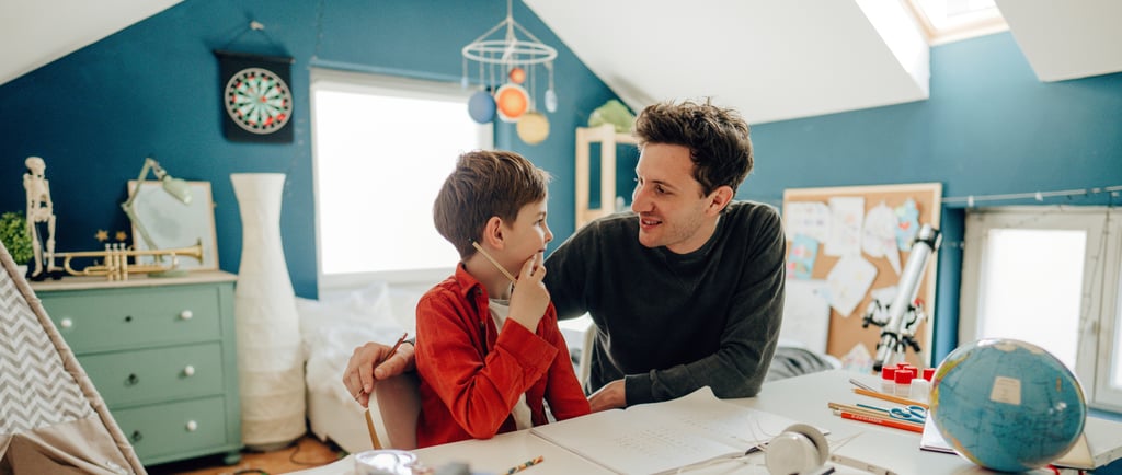father teaching his child at home