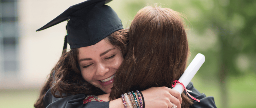 mother hugging homeschool daughter after high school graduation