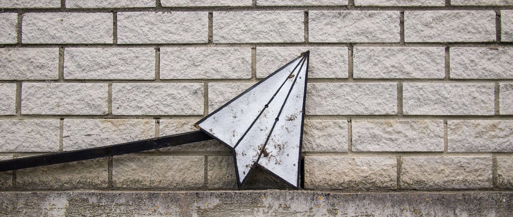 an email sign against a brick wall