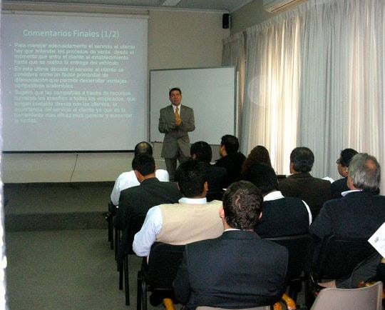 Professional business seminar presentation with a speaker leading a corporate training workshop for an audience.