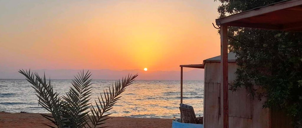 Sunrise and bungalows in front of the sea at Bedouin star Ras shitan Egypt