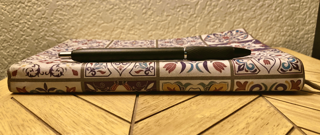 a journal and a pen on a table
