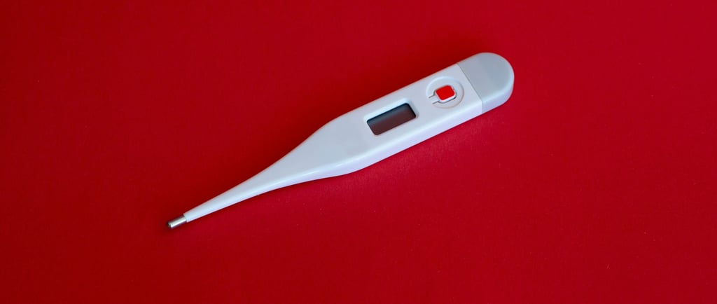 a thermometer against a red background