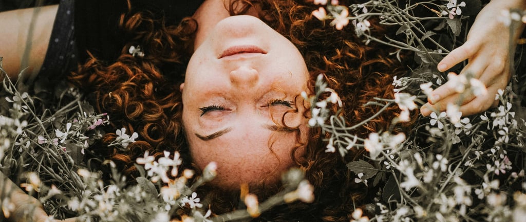 woman lying in a pile of flowers