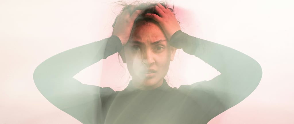 woman holding her head in stress