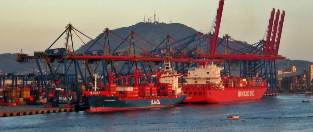 a large ship in the water with a boat in the background