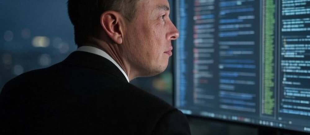 a man in a suit and tie is looking at a computer screen